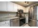 Well-lit kitchen boasting stainless steel appliances and bright white cabinetry at 3655 Habersham Ne Rd # 344, Atlanta, GA 30305