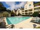 Apartment complex pool with lounge chairs and tables, set against a backdrop of residences under blue skies at 3655 Habersham Ne Rd # 344, Atlanta, GA 30305