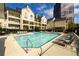 Apartment complex pool with lounge chairs and tables, set against a backdrop of residences under blue skies at 3655 Habersham Ne Rd # 344, Atlanta, GA 30305