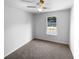 Carpeted bedroom featuring a ceiling fan and a window with a view of the yard at 5920 Rock Rd, Union City, GA 30291