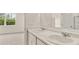 Bathroom featuring dual sinks with white countertops, a large mirror, and a window at 8601 Secretariat Dr, Lithonia, GA 30058