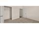 Bedroom features neutral carpet, a closet, and a door to another room at 8601 Secretariat Dr, Lithonia, GA 30058
