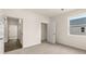 Bedroom features neutral carpet, a window, and doors to other areas of the house at 8601 Secretariat Dr, Lithonia, GA 30058