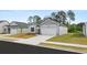 Attractive home featuring a two-car garage, tidy front yard, and complementary landscaping at 8601 Secretariat Dr, Lithonia, GA 30058