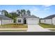 Charming single-story home with a two-car garage, well-manicured lawn, and welcoming front entrance at 8601 Secretariat Dr, Lithonia, GA 30058