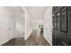 Inviting foyer with dark wood flooring and white trim, offering a glimpse into the open floor plan at 8601 Secretariat Dr, Lithonia, GA 30058