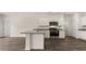 Well-appointed kitchen with white cabinets, stainless steel appliances, and a functional center island at 8601 Secretariat Dr, Lithonia, GA 30058