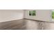 Bright living room with hardwood floors and large window overlooking a green backyard at 8601 Secretariat Dr, Lithonia, GA 30058