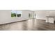 Bright open-concept living room with hardwood floors that connects to a kitchen area with an island at 8601 Secretariat Dr, Lithonia, GA 30058