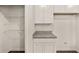 Walk-in pantry featuring built-in shelves and granite countertop space at 8601 Secretariat Dr, Lithonia, GA 30058