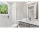 Modern bathroom featuring a tiled walk-in shower, white vanity, and neutral color palette at 2150 Tidwell Ln # 5, Atlanta, GA 30318