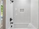 Bright bathroom featuring white subway tile, matte black fixtures, and built-in shelving at 2150 Tidwell Ln # 5, Atlanta, GA 30318