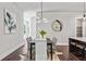 Open-concept dining room with a modern chandelier, decorative mirror, and view into the kitchen at 2150 Tidwell Ln # 5, Atlanta, GA 30318