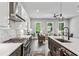 Open-concept kitchen featuring stainless steel appliances, white marble backsplash, island, and views into the living room at 2150 Tidwell Ln # 5, Atlanta, GA 30318