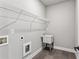 Functional laundry room with sink, wire shelving, and gray tile flooring at 2150 Tidwell Ln # 5, Atlanta, GA 30318