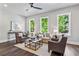 Living room featuring light gray walls, three windows, ceiling fan, and neutral furniture at 2150 Tidwell Ln # 5, Atlanta, GA 30318