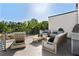 Relaxing outdoor patio setup with comfortable seating, modern furnishings, and a beautiful wooded backdrop at 2150 Tidwell Ln # 5, Atlanta, GA 30318