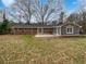 Back exterior view with a well-manicured lawn and neutral paint at 3930 Buck Rd, Powder Springs, GA 30127