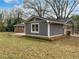 Exterior backyard view with a well-manicured lawn and neutral paint at 3930 Buck Rd, Powder Springs, GA 30127