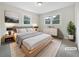 Well-lit bedroom featuring neutral walls, two windows, and stylish decor at 3930 Buck Rd, Powder Springs, GA 30127