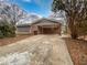 View of home with a driveway, carport, and mix of brick and gray siding at 3930 Buck Rd, Powder Springs, GA 30127