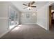 Bright living room featuring carpeted floors and large sliding glass doors leading to the outside at 3930 Buck Rd, Powder Springs, GA 30127