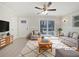 Bright living room with neutral paint, ceiling fan, and sliding glass doors to the backyard at 3930 Buck Rd, Powder Springs, GA 30127