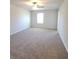 Spacious carpeted bedroom with a large window providing ample natural light and a neutral color palette at 75 Heyman, Covington, GA 30016