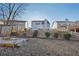 View of the backyard with a fire pit, stairs up a small hill and the back of the home at 807 Plaintain Dr, Woodstock, GA 30188