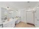 Spacious bathroom featuring double sinks, a full vanity, a large mirror, and a shower and bathtub combination at 807 Plaintain Dr, Woodstock, GA 30188