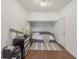 Neutral bedroom with a grey futon, wood floors and closet at 807 Plaintain Dr, Woodstock, GA 30188