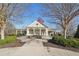 Community clubhouse boasts classic architecture, an American flag, and lush landscaping at 807 Plaintain Dr, Woodstock, GA 30188