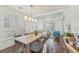 Elegant dining room with a wooden table, shuttered windows, and stylish light fixture at 807 Plaintain Dr, Woodstock, GA 30188