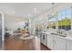 Open kitchen and dining area features stainless steel appliances and view into living space at 807 Plaintain Dr, Woodstock, GA 30188