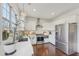 Bright kitchen features white cabinets, stainless steel appliances, undermount sink, and hardwood floors at 807 Plaintain Dr, Woodstock, GA 30188