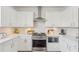 Close up of the kitchen features white cabinets and stainless steel appliances at 807 Plaintain Dr, Woodstock, GA 30188