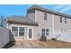 View of the backyard with white vinyl fence, door, and several windows on this two-story townhome at 2555 Flat Shoals Rd # 1705, Atlanta, GA 30349