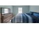 Serene main bedroom featuring a queen bed, neutral walls and a dresser with mirror at 2555 Flat Shoals Rd # 1705, Atlanta, GA 30349