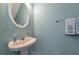 Bright powder room with a pedestal sink and decorative mirror at 2555 Flat Shoals Rd # 1705, Atlanta, GA 30349