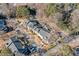 Overhead view displays a condo community with mature trees, manicured lawns, and convenient parking at 6420 Magnolia Way, Morrow, GA 30260