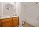 Bathroom with a wooden vanity, oval mirror, and a shower-tub combination at 6420 Magnolia Way, Morrow, GA 30260