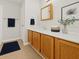 Bathroom vanity with wood cabinets, white countertops and decorative accents at 6420 Magnolia Way, Morrow, GA 30260