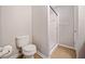 Bathroom with a toilet and shower featuring a glass door at 6420 Magnolia Way, Morrow, GA 30260