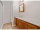 Bathroom featuring a tiled shower, modern vanity with a white counter and wood cabinets at 6420 Magnolia Way, Morrow, GA 30260