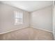 Cozy bedroom with a neutral carpet and large window, providing natural light at 6420 Magnolia Way, Morrow, GA 30260