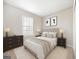 Cozy bedroom featuring a plush bed with stylish decor, soft lighting, and a large window at 6420 Magnolia Way, Morrow, GA 30260