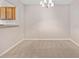 Comfortable dining area featuring plush carpet, a stylish chandelier, and an open view of the kitchen at 6420 Magnolia Way, Morrow, GA 30260