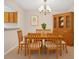 Inviting dining room featuring wood furniture, a hutch, and a stylish chandelier, perfect for entertaining at 6420 Magnolia Way, Morrow, GA 30260