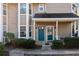 Inviting condo entrance featuring double front doors, a cozy porch, and manicured shrubs for curb appeal at 6420 Magnolia Way, Morrow, GA 30260
