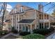 Charming condo featuring a well-maintained yard with mature landscaping, a covered porch, and a private balcony at 6420 Magnolia Way, Morrow, GA 30260